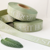 Logo Printed Onto A Sage Green Ribbon